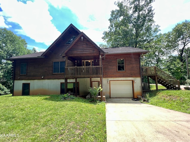 log home with a garage and a front lawn