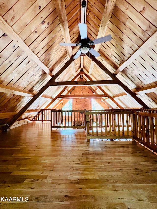 additional living space with hardwood / wood-style flooring, wooden ceiling, and lofted ceiling with beams