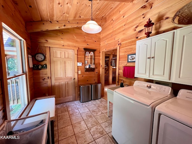 clothes washing area with wood walls, wooden ceiling, light tile patterned floors, and a healthy amount of sunlight