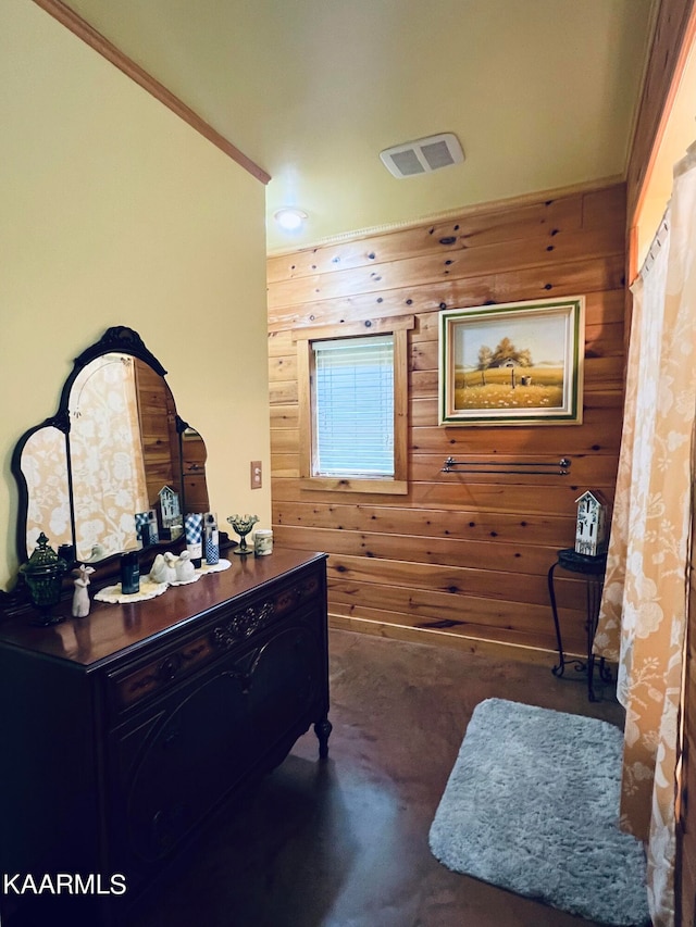 interior space with wood walls and ornamental molding