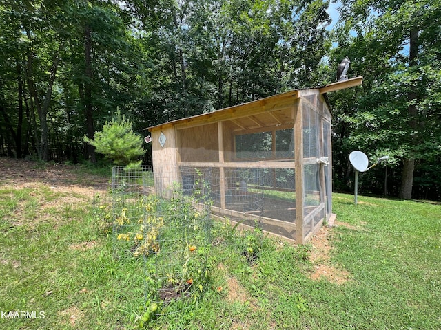 view of outbuilding featuring a lawn