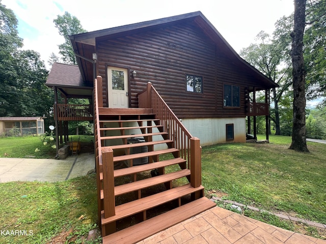 exterior space with a lawn and a wooden deck