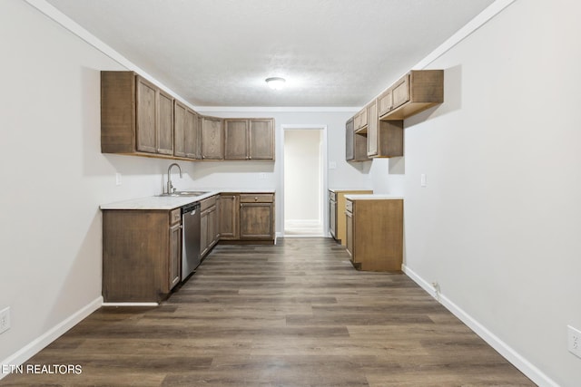 kitchen with dishwasher, sink, a textured ceiling, dark wood-type flooring, and crown molding