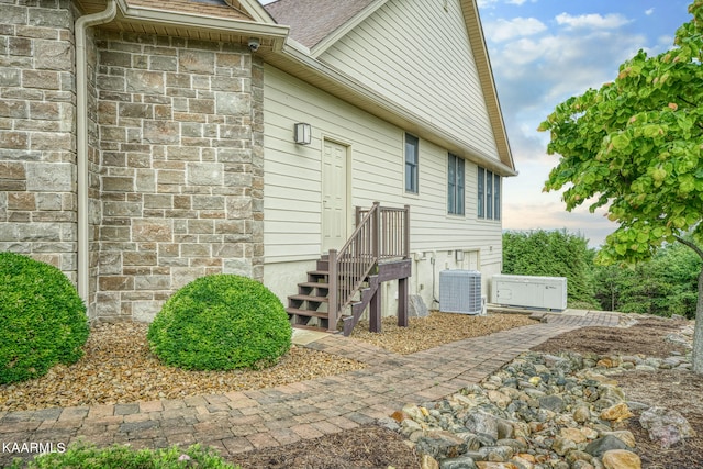 view of exterior entry with central AC unit