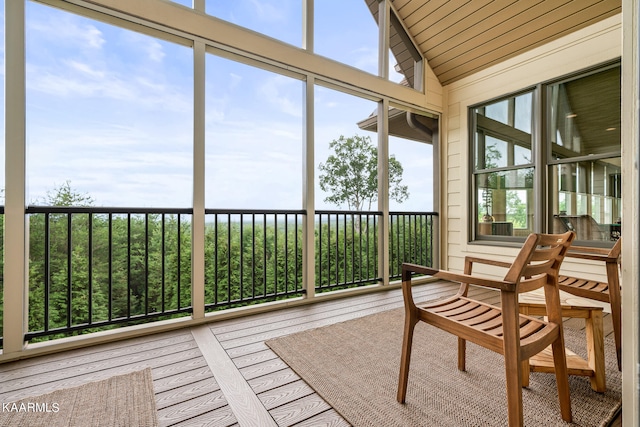 sunroom featuring lofted ceiling and a wealth of natural light