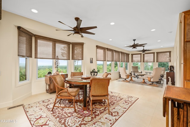 tiled dining area with ceiling fan