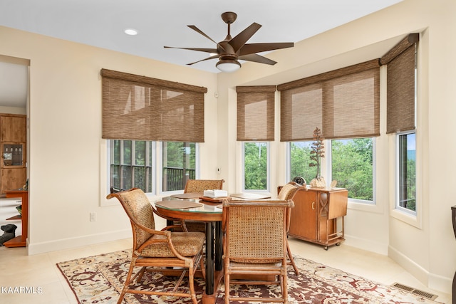 dining area featuring ceiling fan and light tile floors