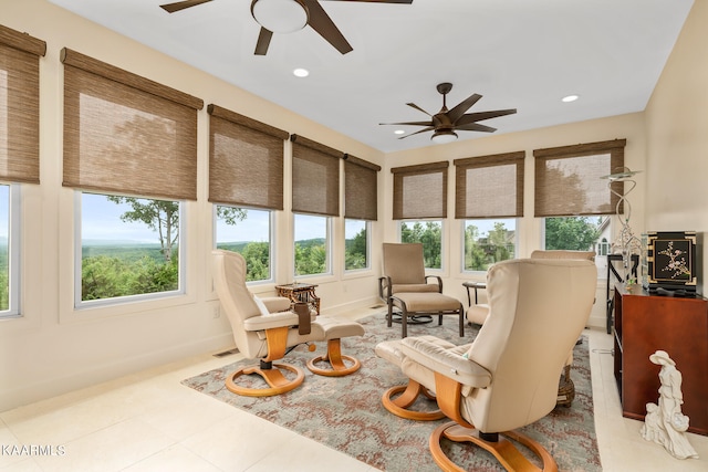 sunroom / solarium featuring a healthy amount of sunlight and ceiling fan