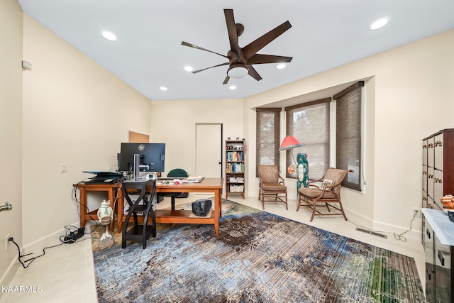 carpeted home office featuring ceiling fan