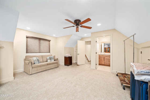 living area with light colored carpet and ceiling fan