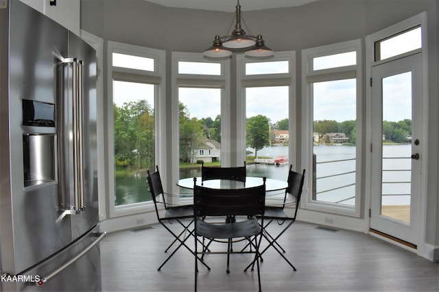 dining area featuring a chandelier, a healthy amount of sunlight, and light hardwood / wood-style flooring