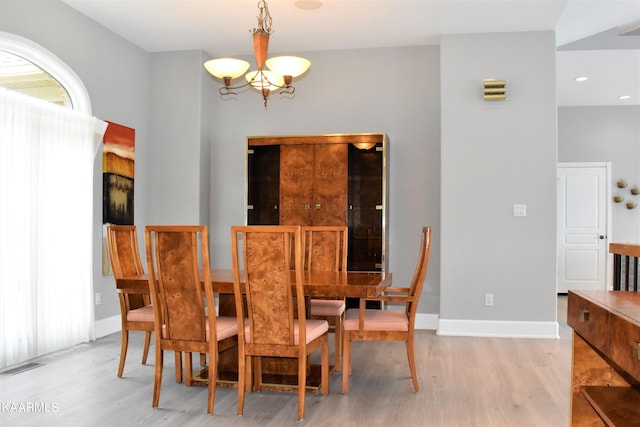 dining area featuring a chandelier and light wood-type flooring