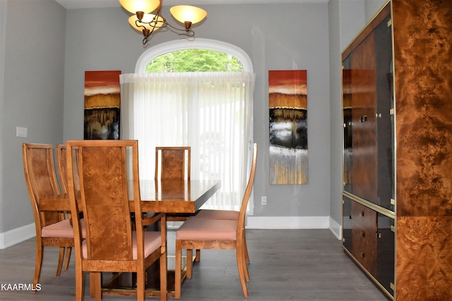 dining area featuring a notable chandelier and dark hardwood / wood-style floors