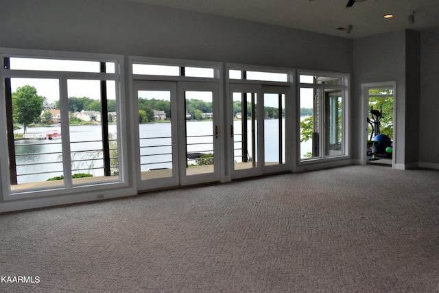 interior space featuring a water view and a healthy amount of sunlight