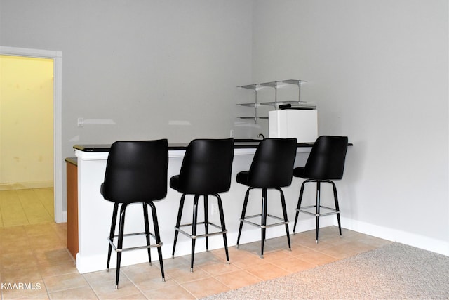 bar featuring light tile floors