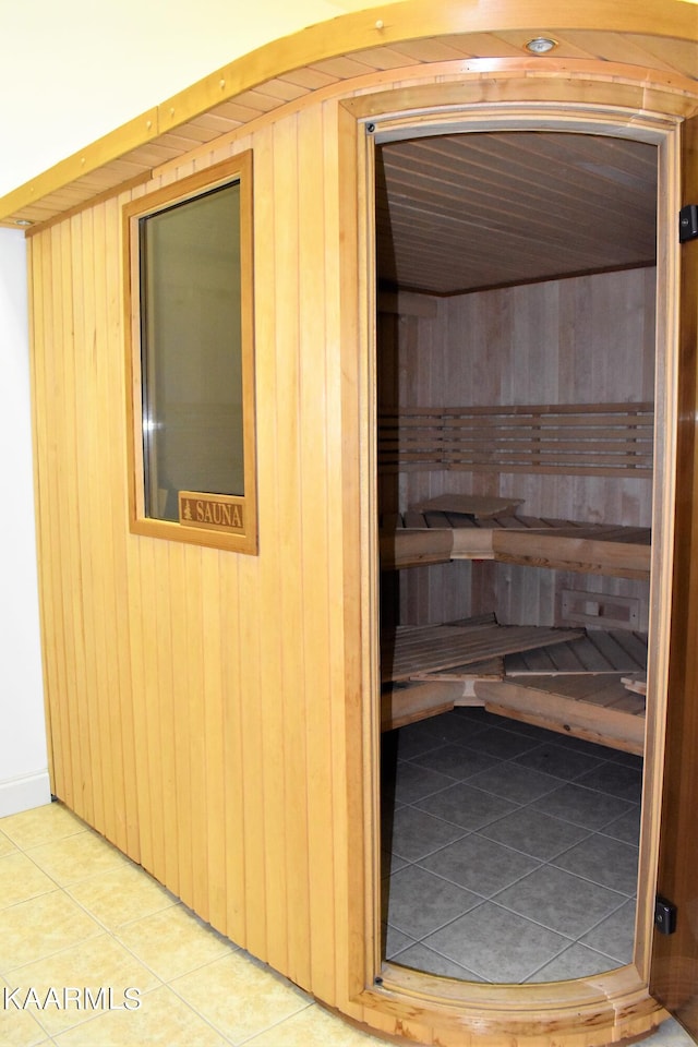 view of sauna / steam room with wood walls and tile flooring