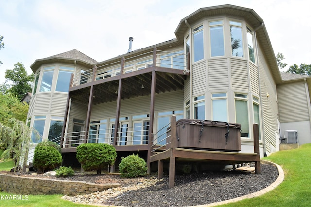 rear view of property with a balcony and central air condition unit