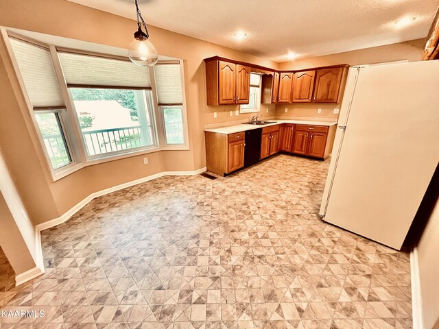 kitchen featuring light tile floors, dishwasher, decorative light fixtures, sink, and white refrigerator