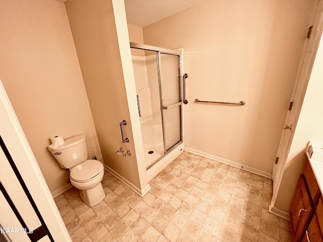 bathroom with tile floors, toilet, a shower with door, and a textured ceiling