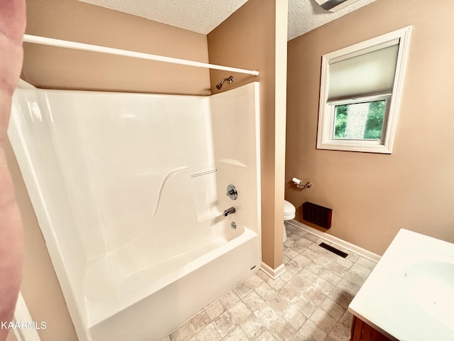 full bathroom with tile floors, a textured ceiling, toilet, vanity, and shower / bathtub combination