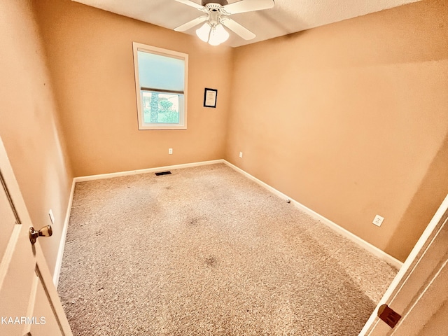 unfurnished room featuring ceiling fan and carpet