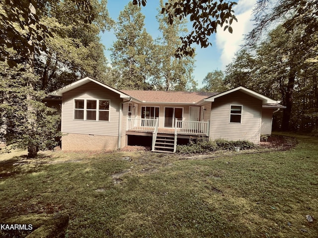 rear view of house featuring a lawn