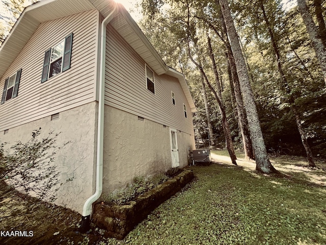 view of side of home featuring a yard