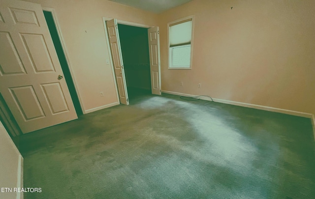 unfurnished bedroom with dark carpet