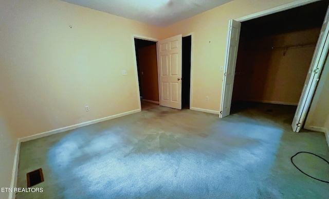 unfurnished bedroom featuring a closet and light carpet