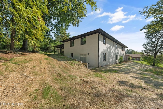 view of side of property with a lawn