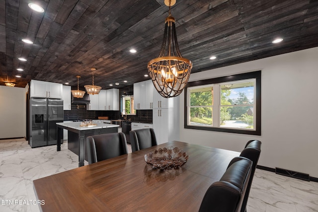 dining space with wood ceiling, an inviting chandelier, light tile patterned floors, and sink