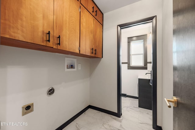 clothes washing area featuring hookup for a washing machine, cabinets, light tile patterned floors, and hookup for an electric dryer