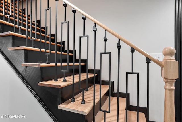 stairway featuring hardwood / wood-style flooring