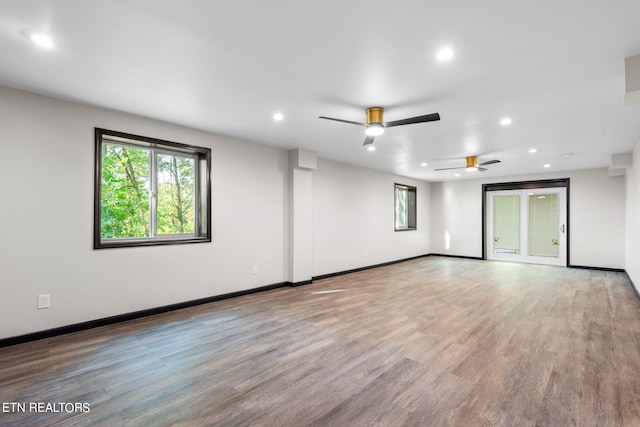 empty room with hardwood / wood-style floors and ceiling fan