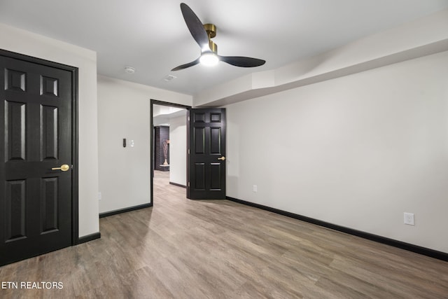 unfurnished bedroom with ceiling fan and light hardwood / wood-style floors