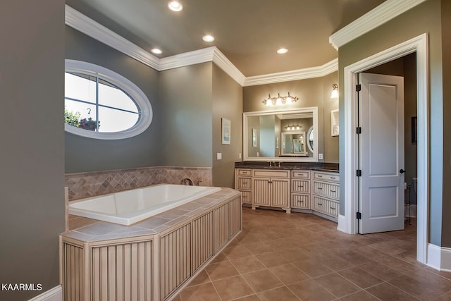 bathroom with vanity, a bathing tub, tile patterned flooring, and ornamental molding