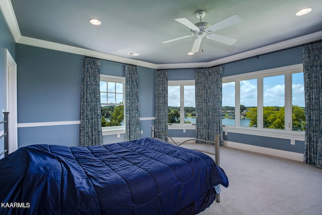 carpeted bedroom featuring ornamental molding, a water view, multiple windows, and ceiling fan