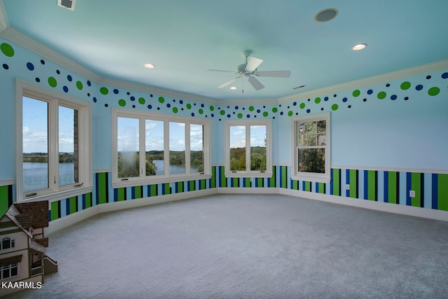 interior space with ceiling fan, plenty of natural light, and a water view