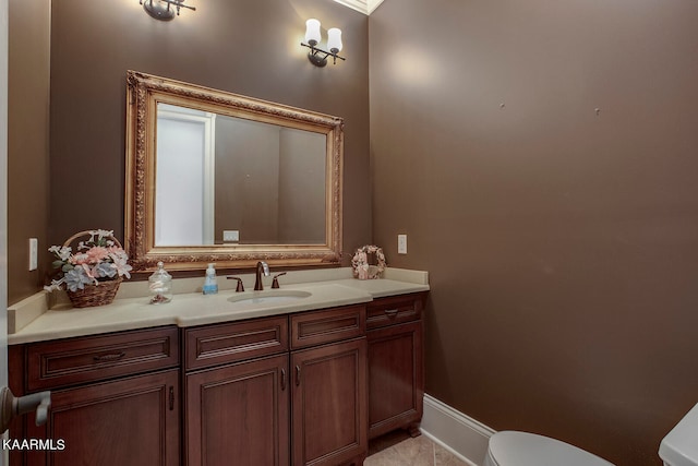 bathroom featuring tile patterned flooring, vanity, and toilet