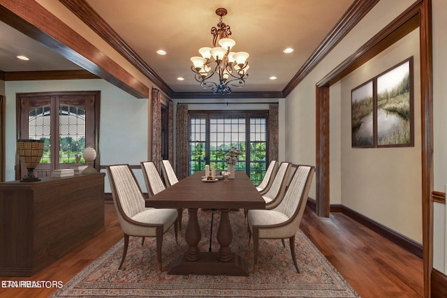 dining area with a notable chandelier, crown molding, and dark hardwood / wood-style flooring