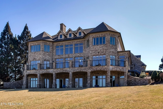 view of front of home featuring a balcony and a front yard