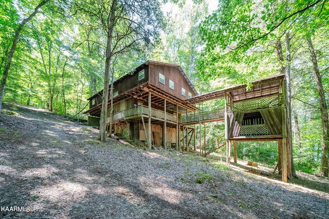 back of property featuring a wooden deck