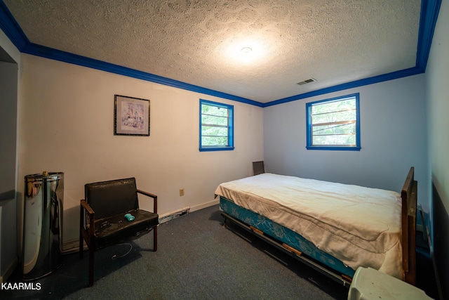 bedroom featuring a textured ceiling and dark colored carpet