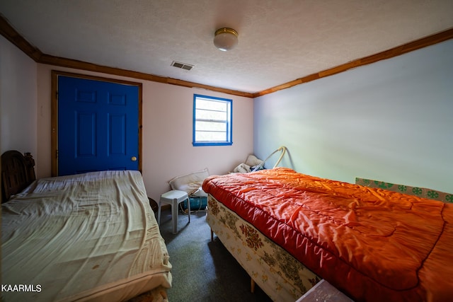 carpeted bedroom with a textured ceiling and ornamental molding