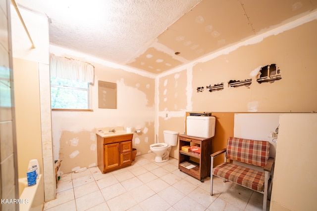 interior space featuring vanity, a textured ceiling, tile flooring, toilet, and shower / bath combination