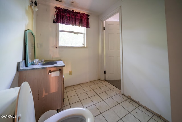 bathroom featuring tile floors, toilet, and vanity