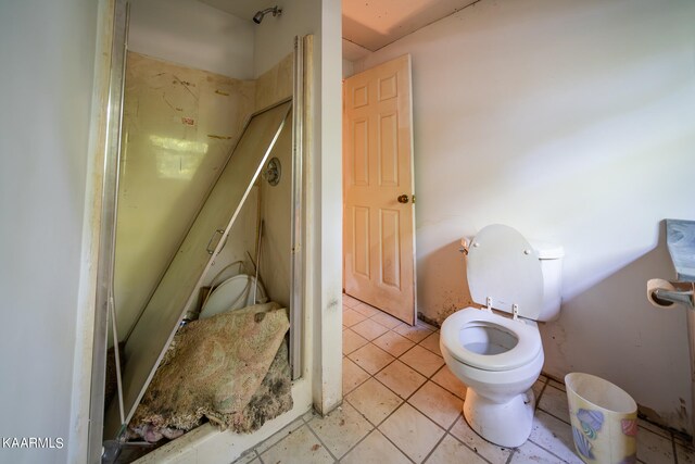 bathroom with toilet and tile flooring