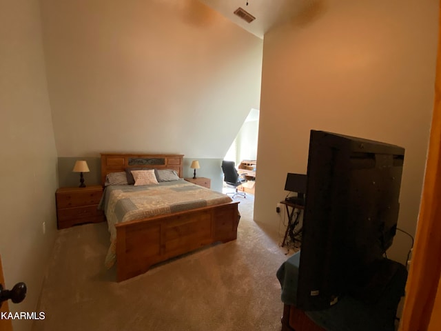 carpeted bedroom featuring vaulted ceiling