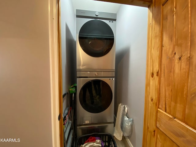 clothes washing area with stacked washer and dryer