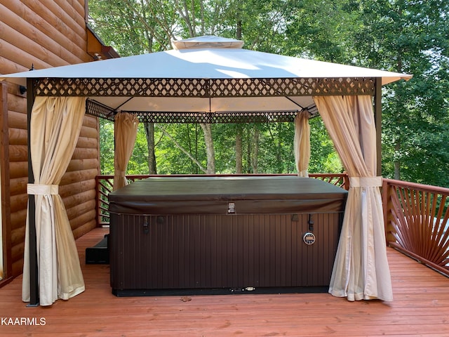 deck with a gazebo and a hot tub